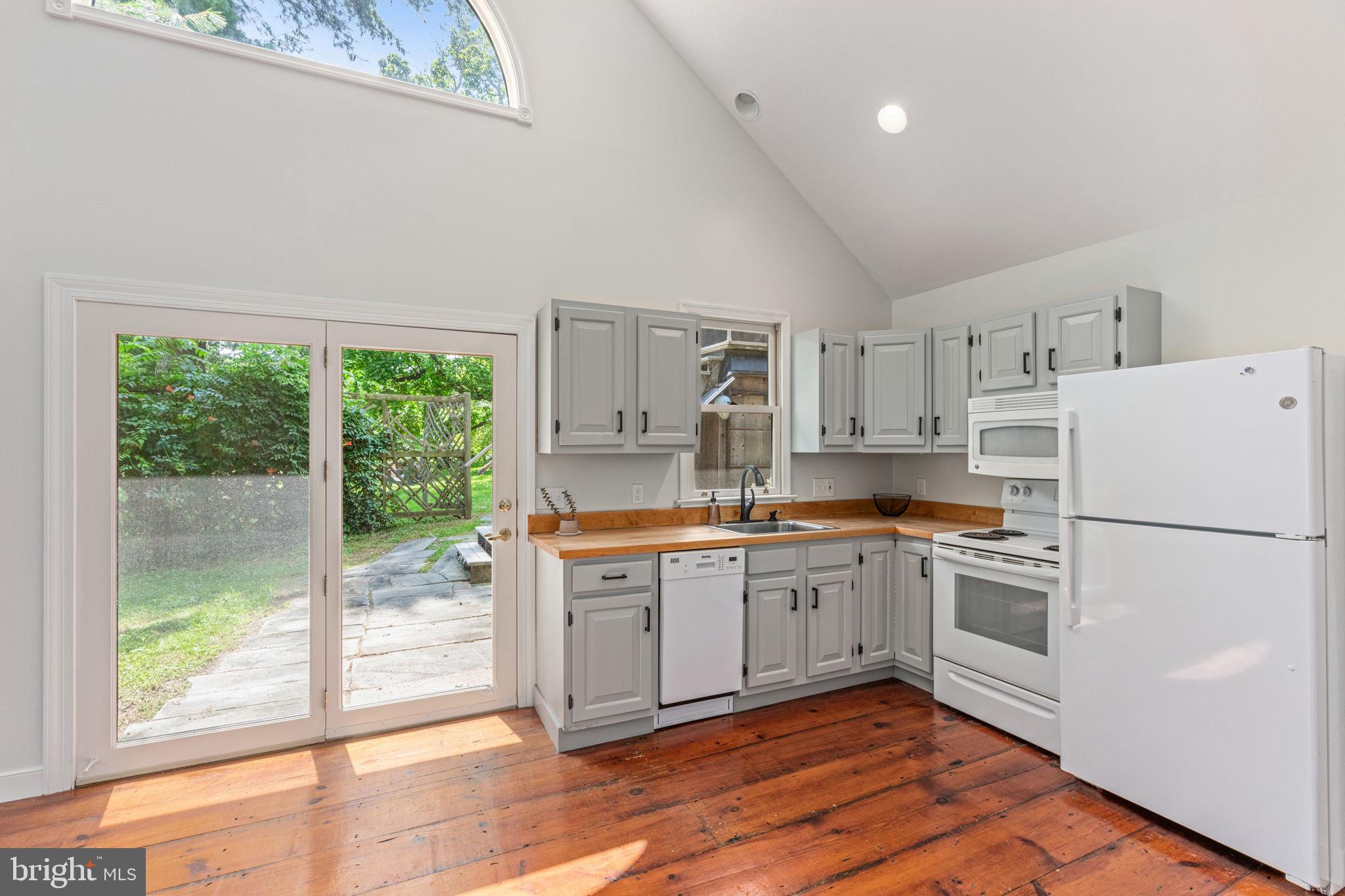 137 Callowhill Road Chalfont, PA 18914 - Photo 46 of 59 a kitchen with a refrigerator a stove top oven and a large window