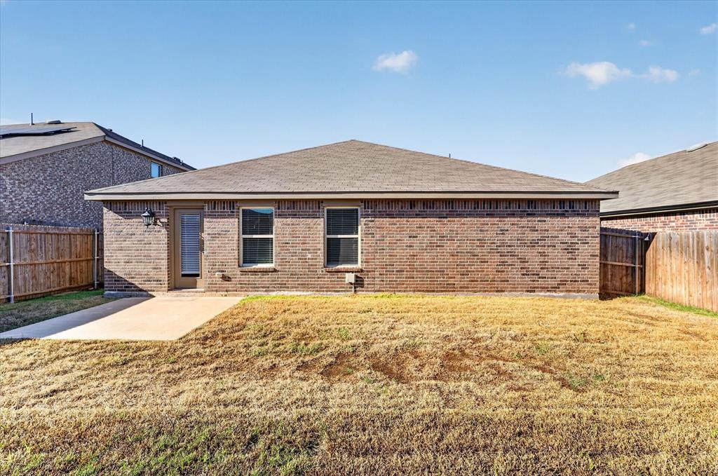 2428 Rosharon Drive Forney, TX 75126 - Photo 27 of 40 Brick single-story home featuring a hipped roof, multiple windows with dark frames, and a covered front entry