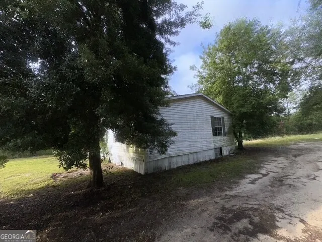 a view of a backyard with large trees