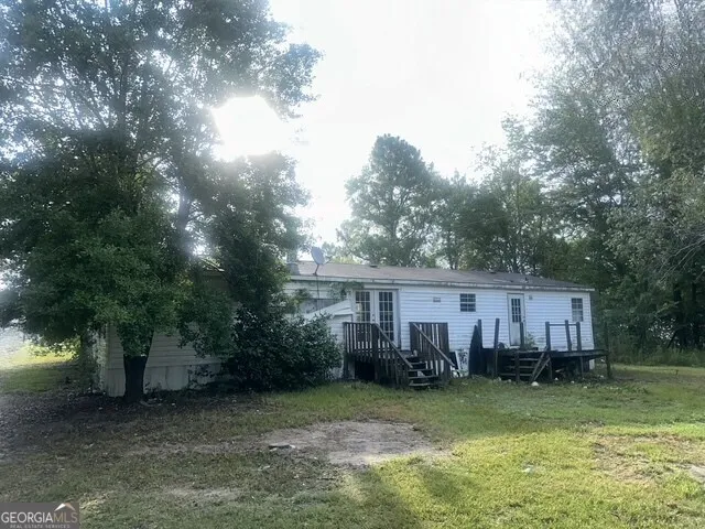 a view of a house with a backyard