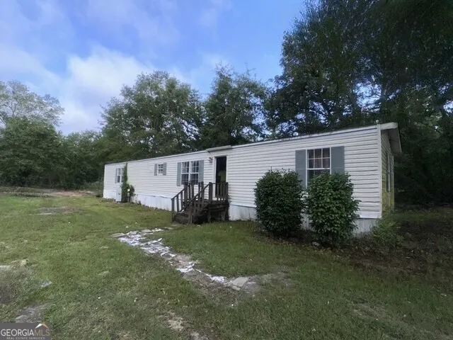 a view of a house with a yard and garage
