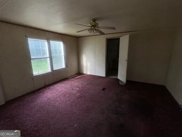 an empty room with windows and closet