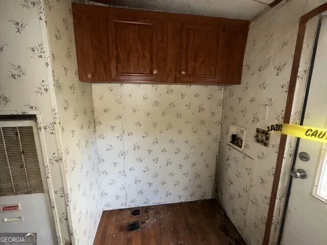 a bathroom with a sink and a wooden floor