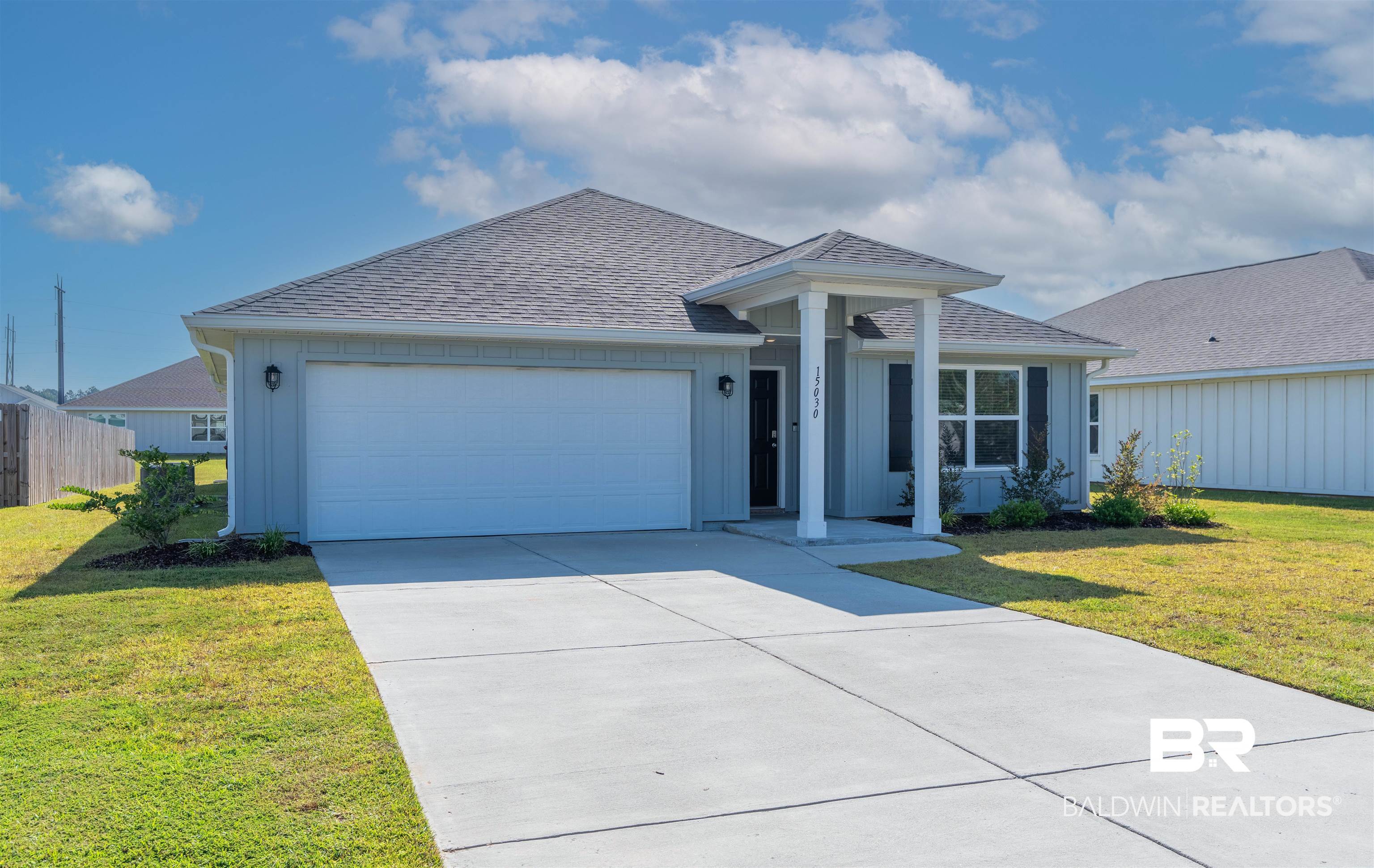 15030 Forsythia Loop Silverhill, AL 36576 - Photo 2 of 33 Ranch-style house with a shingled roof, concrete driveway, an attached garage, and board and batten siding