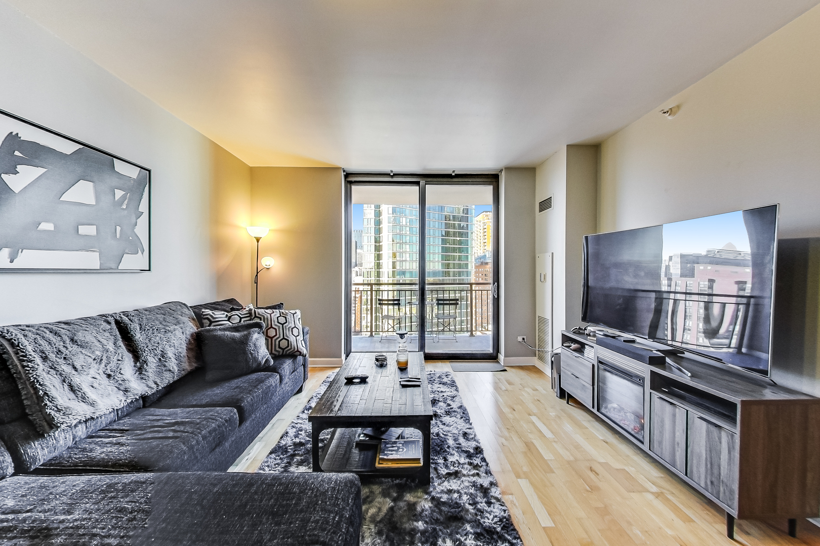 1101 South State Street, Unit 2001 Chicago, IL 60605 - Photo 7 of 24 a living room with furniture and a flat screen tv