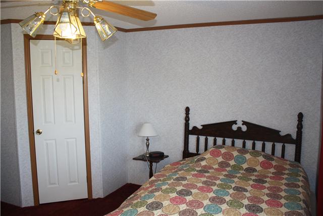 4372 Elkwood Section Road Ardmore, AL 35739 - Photo 15 of 20 a bedroom with a bed and a chandelier