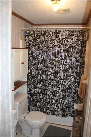 4372 Elkwood Section Road Ardmore, AL 35739 - Photo 16 of 20 a bathroom with a toilet and a shower curtain