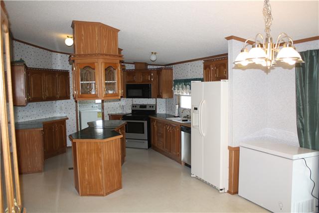 4372 Elkwood Section Road Ardmore, AL 35739 - Photo 8 of 20 a kitchen with stainless steel appliances granite countertop a refrigerator a stove top oven a sink and dishwasher