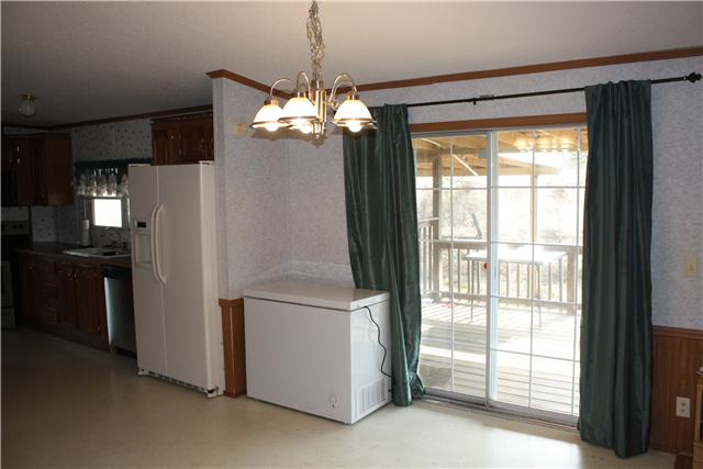 4372 Elkwood Section Road Ardmore, AL 35739 - Photo 9 of 20 a view of a kitchen with a stove fridge and wooden floor