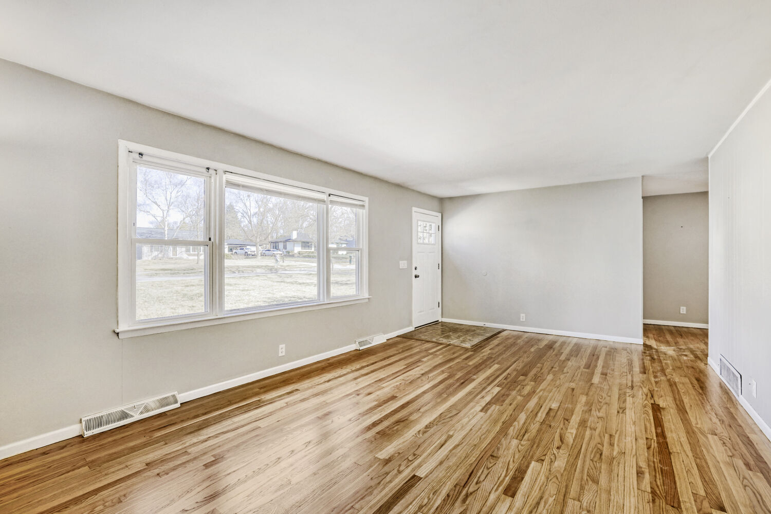 3 Sunset Lane Algonquin, IL 60102 - Photo 11 of 23 a view of an empty room with wooden floor and a window