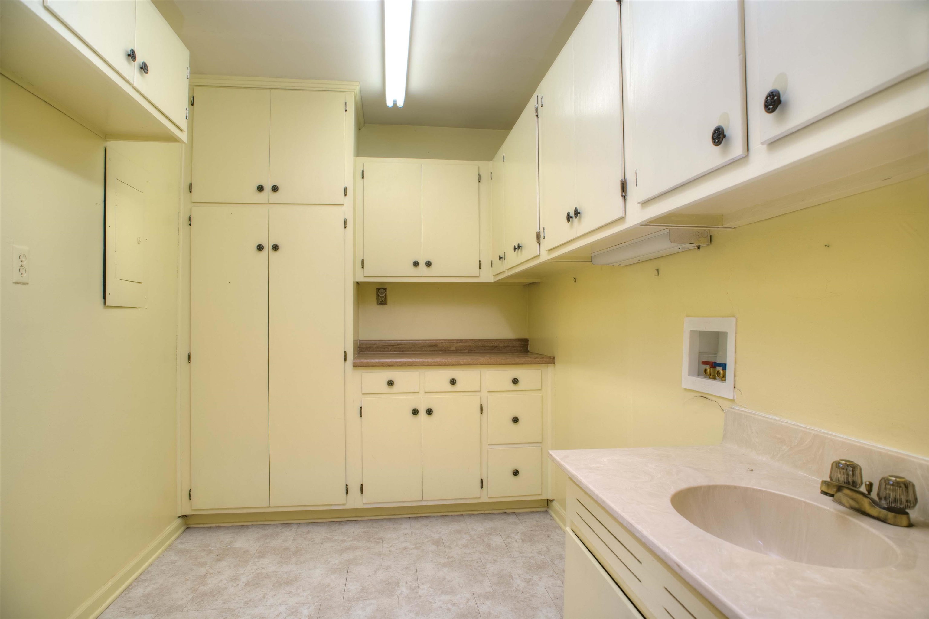 5760 Foxdale Road Memphis, TN 38115 - Photo 9 of 21 Laundry Room/Pantry/Half Bath with 21 Cabinets and 5 Drawers and Sink
