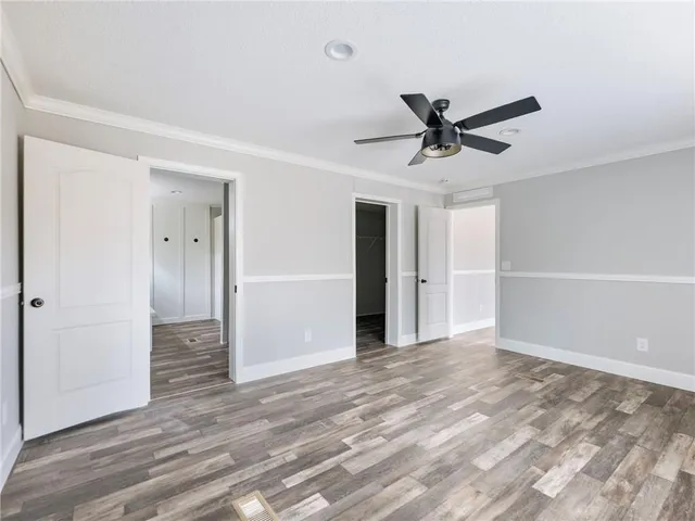 a view of a livingroom with a ceiling fan and window