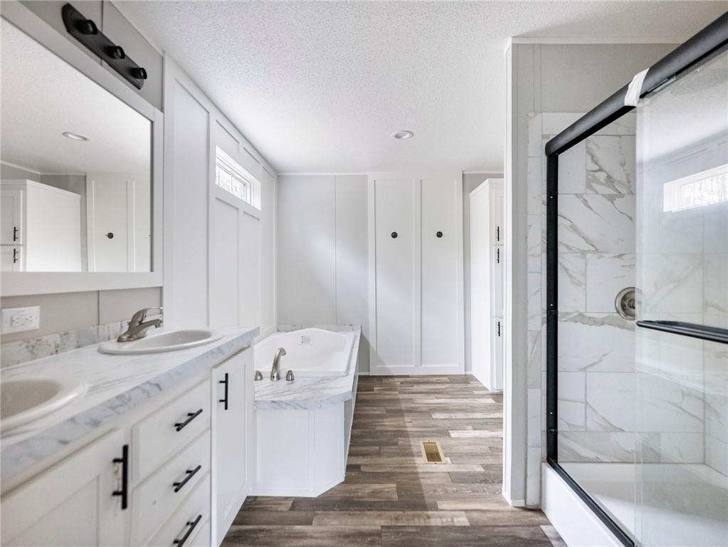 5230 Bogus Road Commerce, GA 30530 - Photo 15 of 45 a bathroom with a sink and a mirror with bathtub
