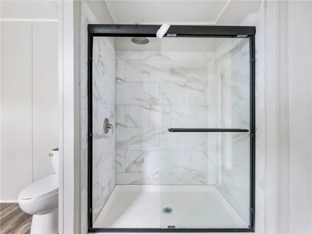 a bathroom with a glass shower door