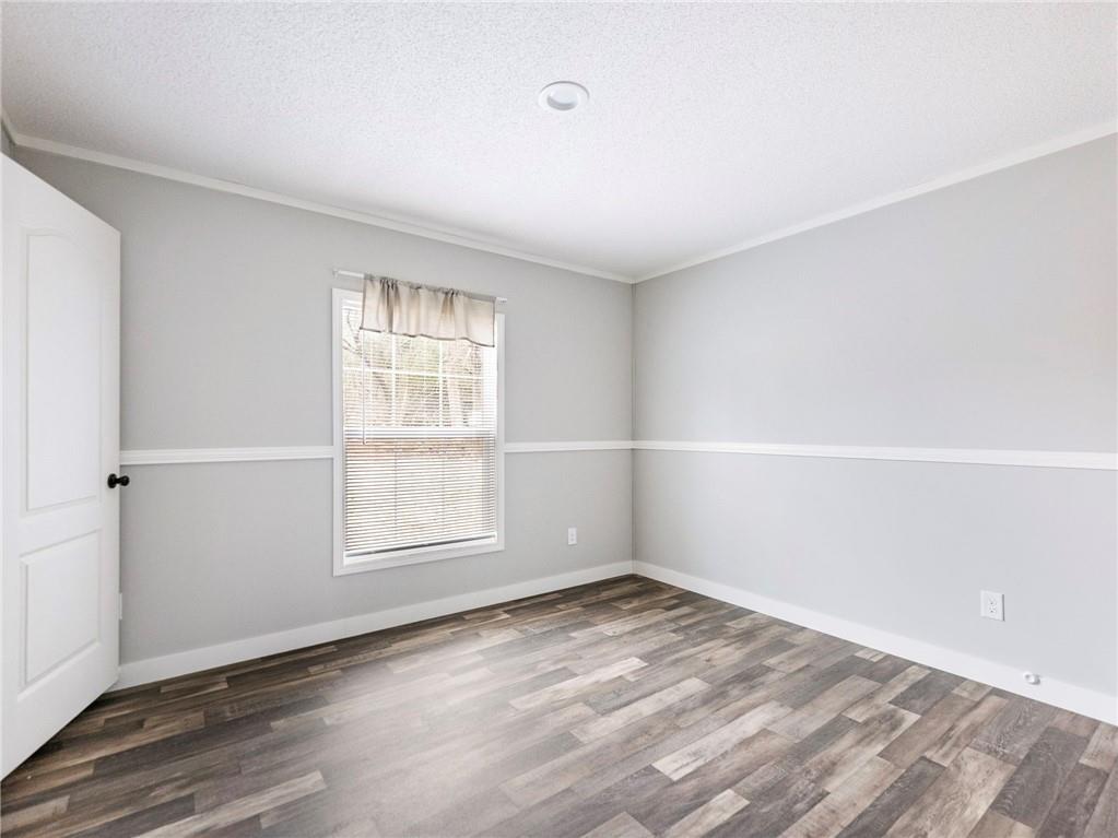 5230 Bogus Road Commerce, GA 30530 - Photo 20 of 45 an empty room with wooden floor and windows