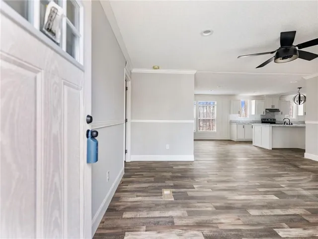 a view of a kitchen with a refrigerator and a window