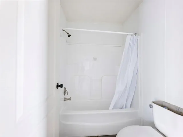 a bathroom with a bathtub and a toilet