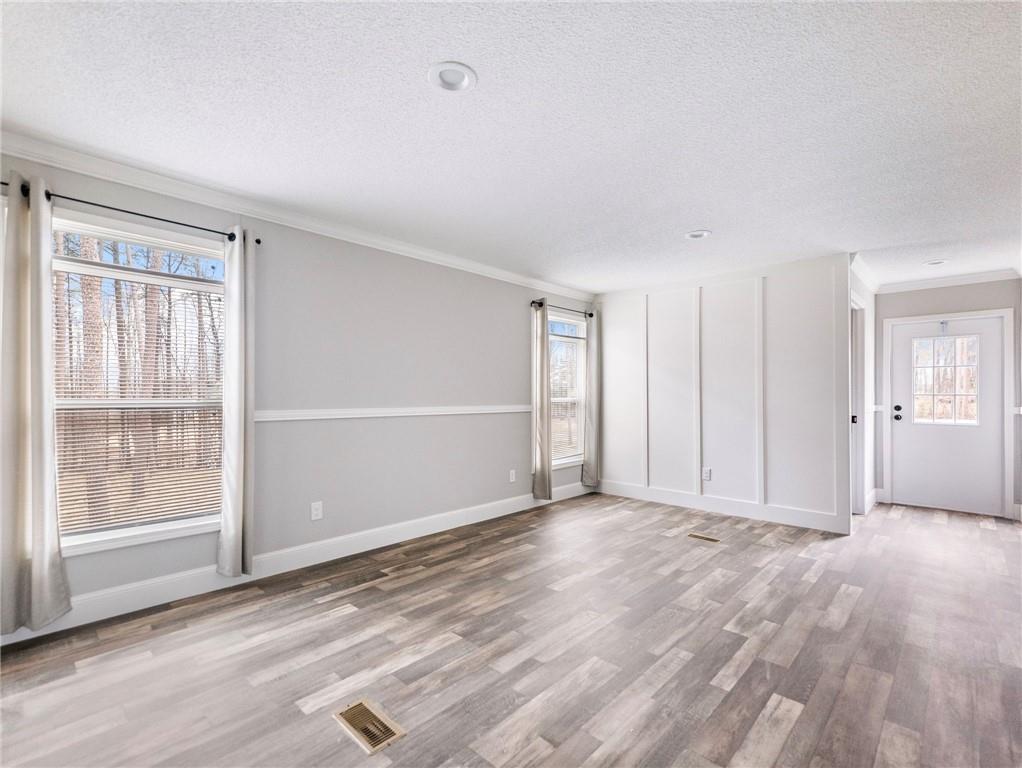 5230 Bogus Road Commerce, GA 30530 - Photo 26 of 45 a view of an empty room with wooden floor and windows