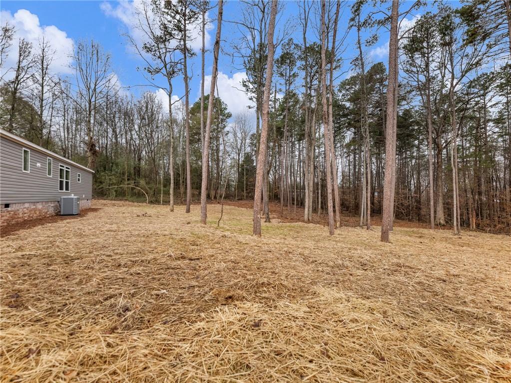 5230 Bogus Road Commerce, GA 30530 - Photo 36 of 45 a backyard of a house with lots of green space