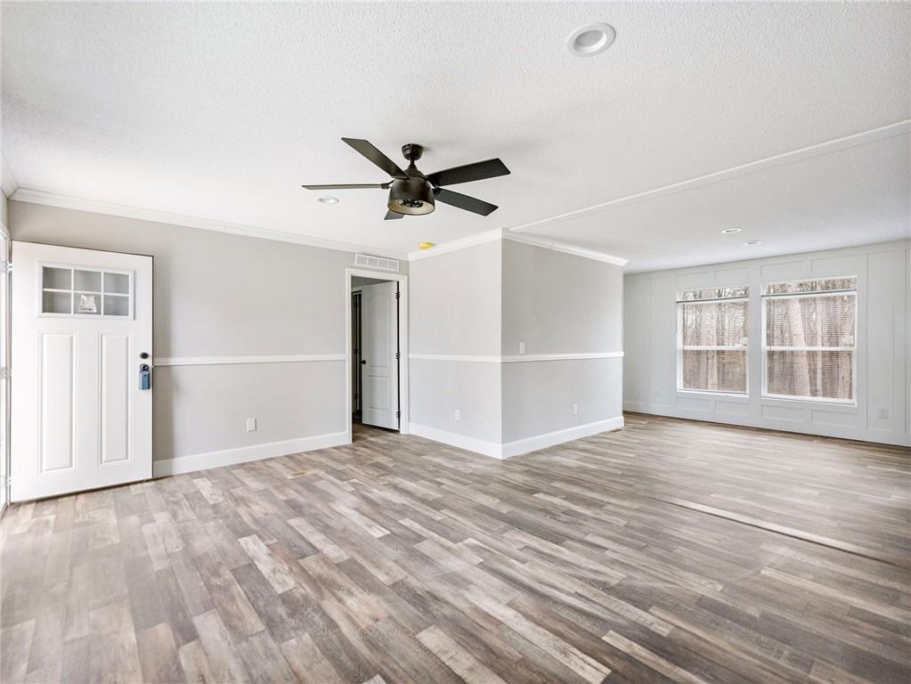 5230 Bogus Road Commerce, GA 30530 - Photo 4 of 45 a view of an empty room with a window and wooden floor