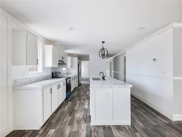 a kitchen with sink cabinets and wooden floor