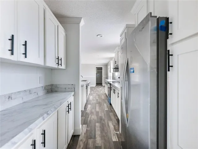 a view of a kitchen with a sink and dishwasher