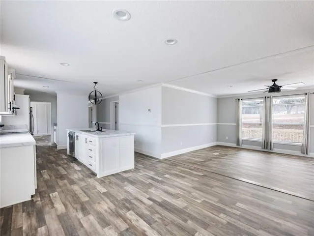 a view of a kitchen with furniture and wooden floor
