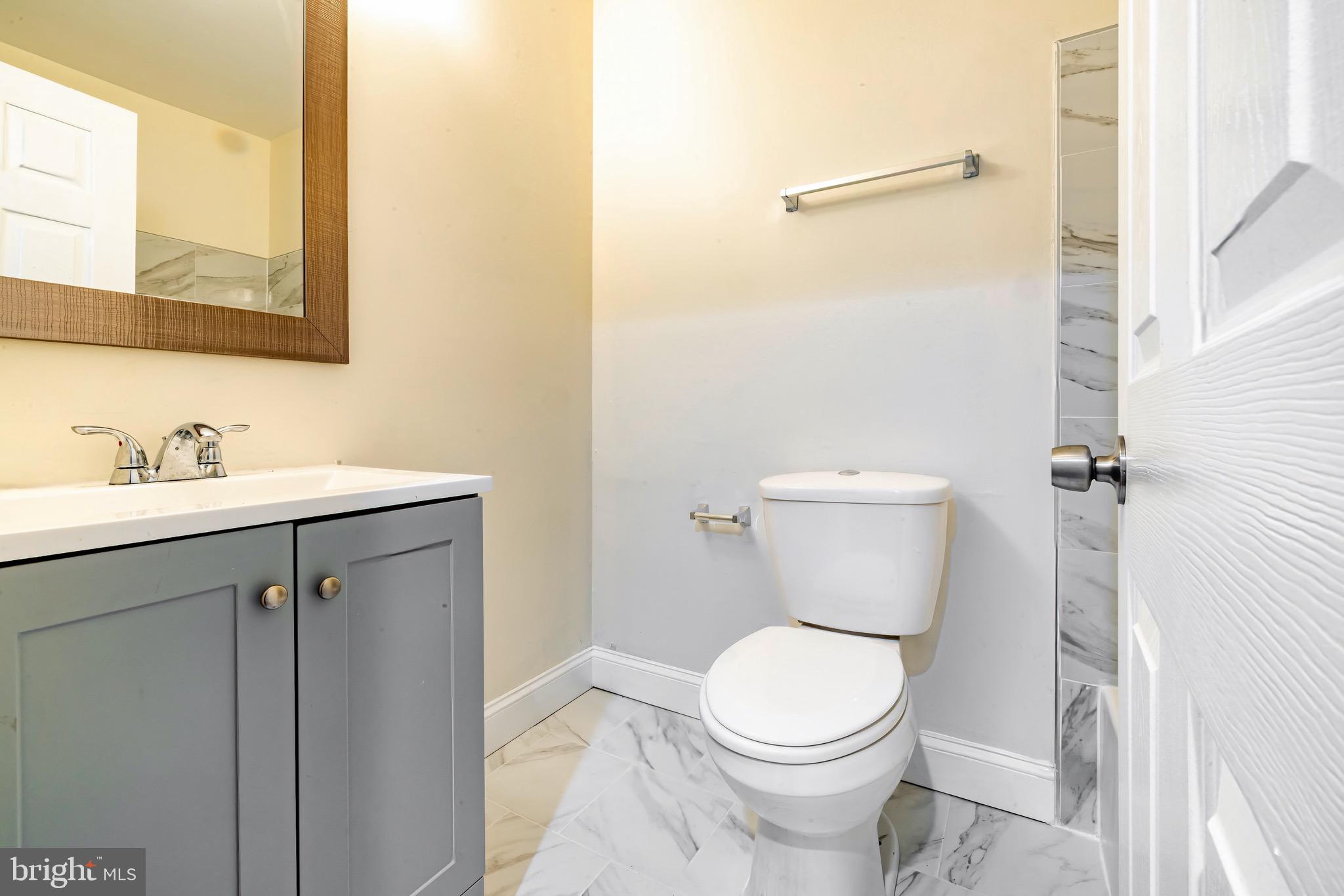 1209 Timber Creek Road Clementon, NJ 08021 - Photo 14 of 23 a bathroom with a toilet sink and mirror