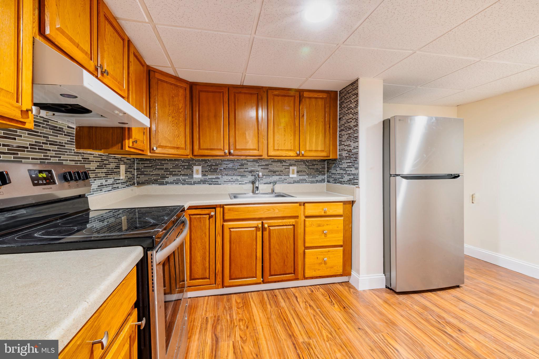 1209 Timber Creek Road Clementon, NJ 08021 - Photo 2 of 23 a kitchen with stainless steel appliances granite countertop a refrigerator a sink and a stove