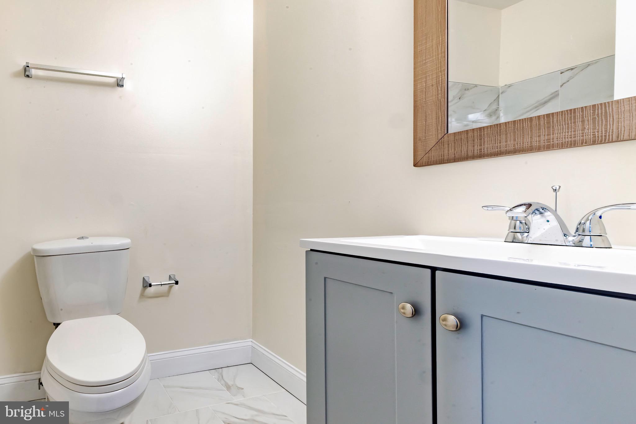 1209 Timber Creek Road Clementon, NJ 08021 - Photo 21 of 23 a bathroom with a toilet a sink and mirror