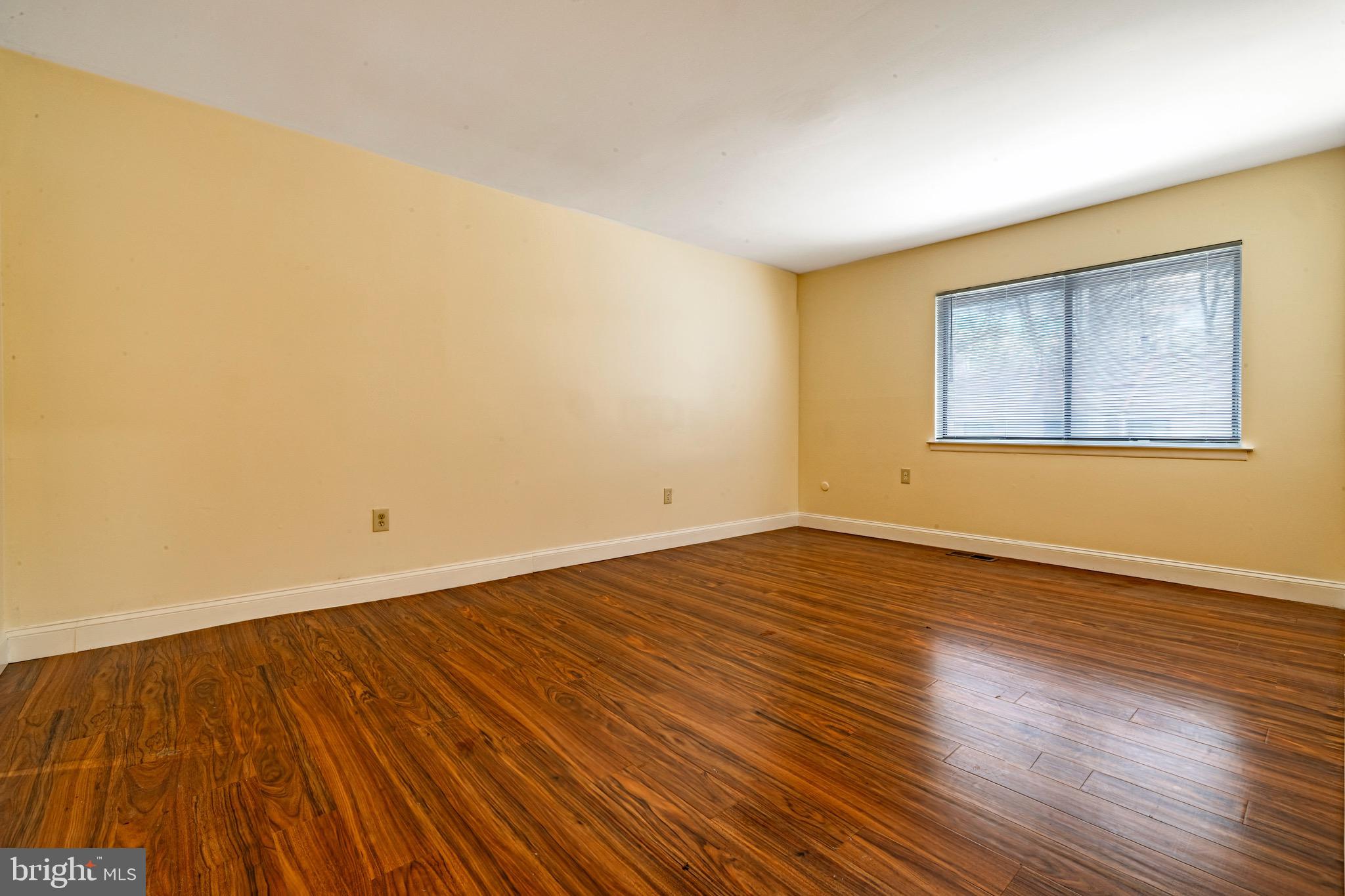 1209 Timber Creek Road Clementon, NJ 08021 - Photo 22 of 23 a view of an empty room with wooden floor and a window