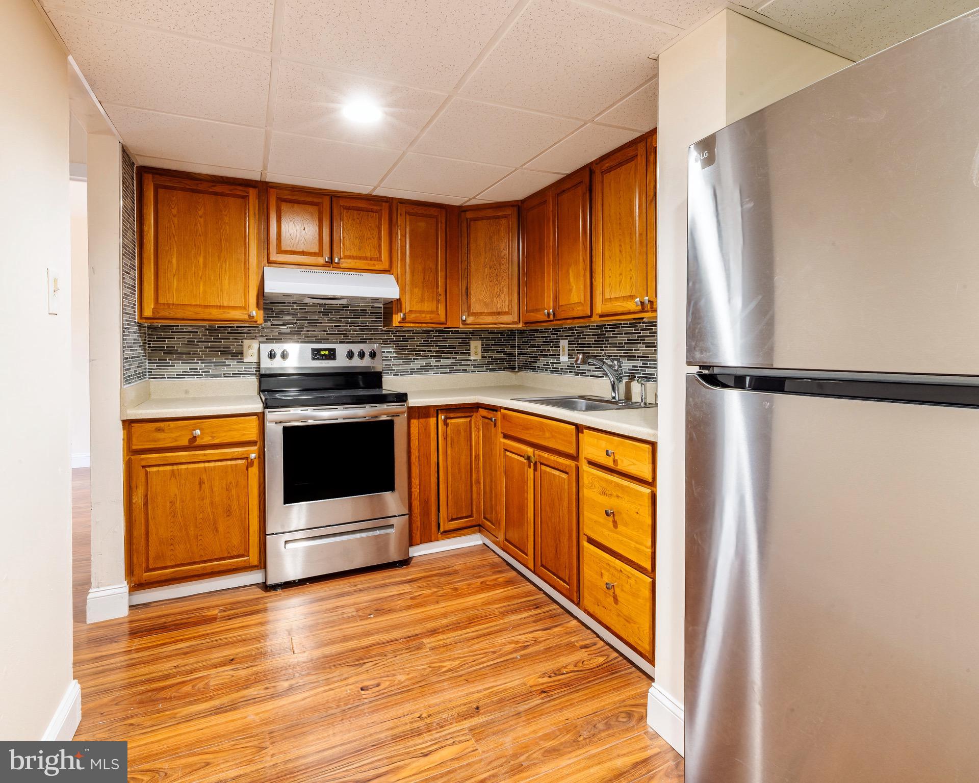 1209 Timber Creek Road Clementon, NJ 08021 - Photo 3 of 23 a kitchen with stainless steel appliances granite countertop a stove a refrigerator and a sink