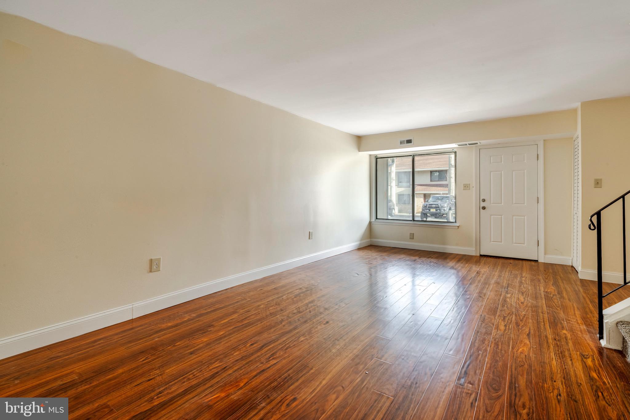 1209 Timber Creek Road Clementon, NJ 08021 - Photo 9 of 23 wooden floor in an empty room with a window