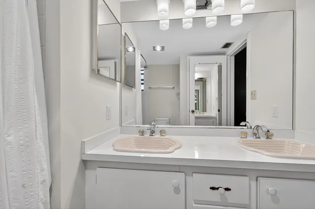 a bathroom with a sink double vanity and a mirror