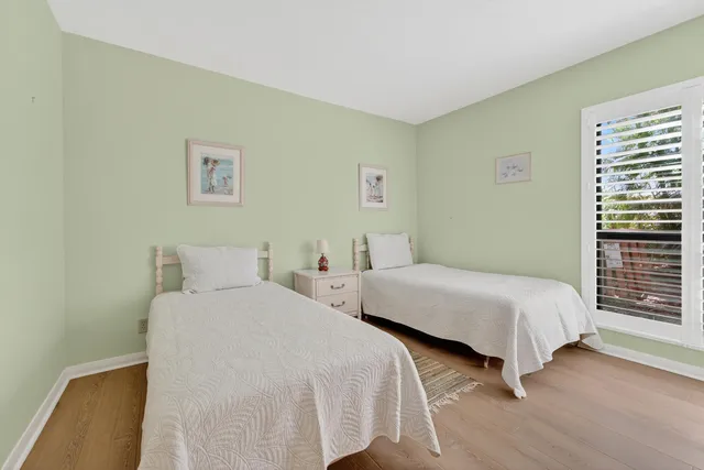 a bedroom with two beds and a window