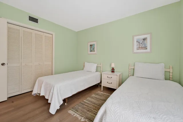 a bedroom with a bed and a night stand