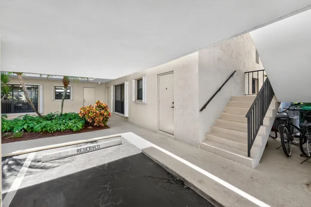 an aerial view of a house with swimming pool and a chairs