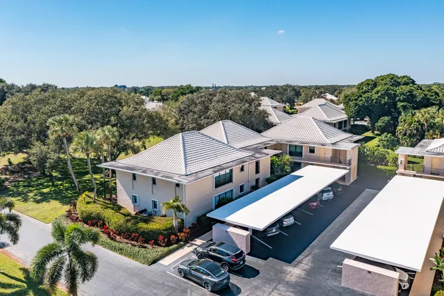 an aerial view of multiple houses with yard