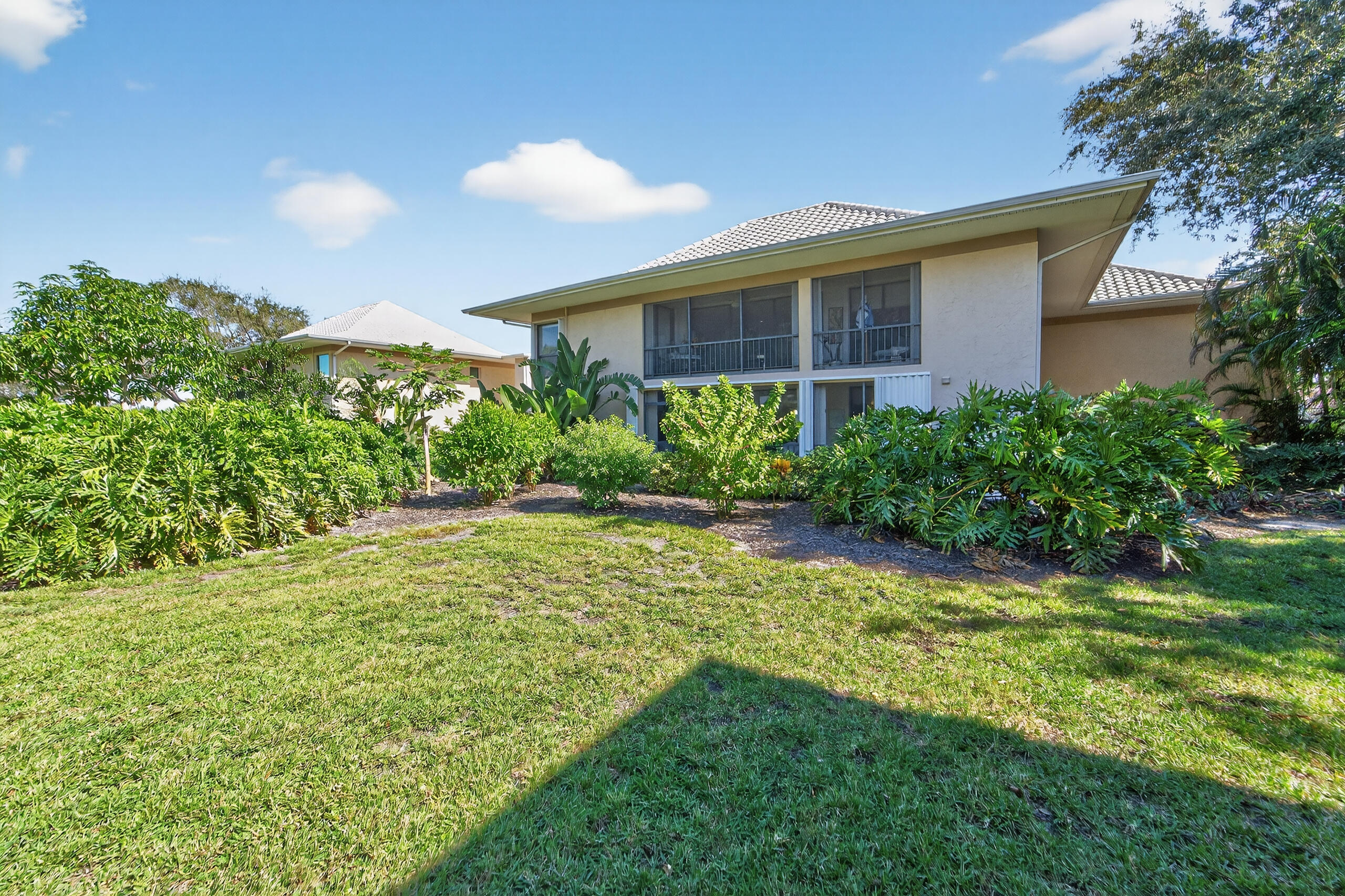 6 Concourse Drive, Unit A Jupiter, FL 33469 - Photo 33 of 49 a view of a house with a yard and plants