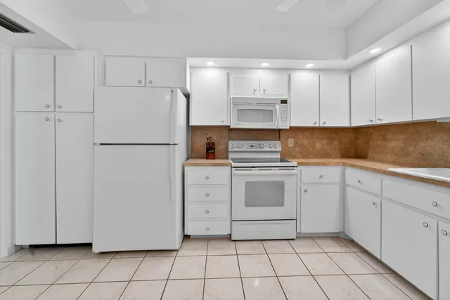 a kitchen with cabinets appliances and a sink