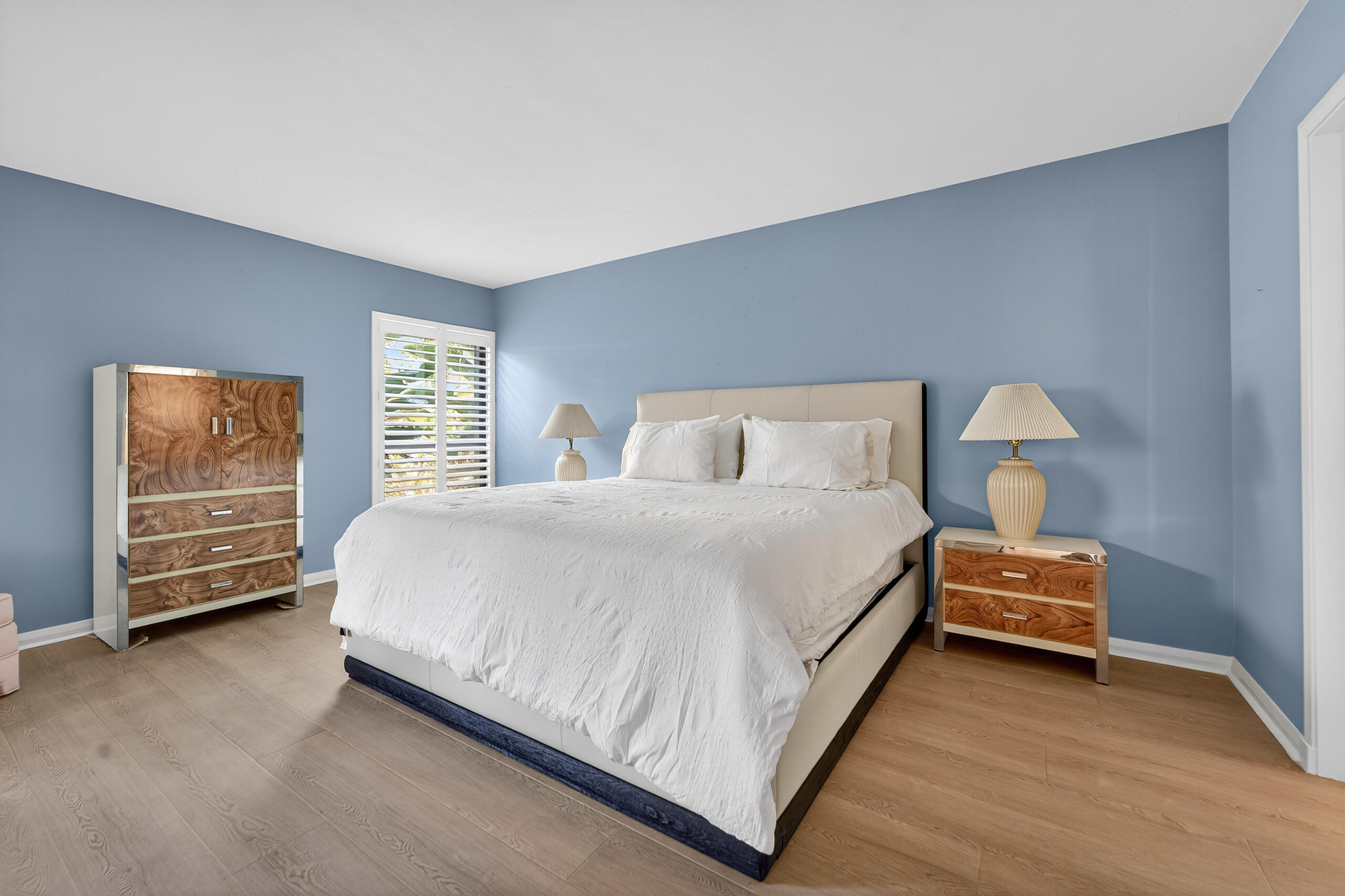 6 Concourse Drive, Unit A Jupiter, FL 33469 - Photo 8 of 49 a bedroom with a bed and a tv on the dresser