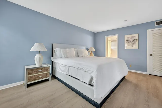 a bedroom with a bed and a night stand