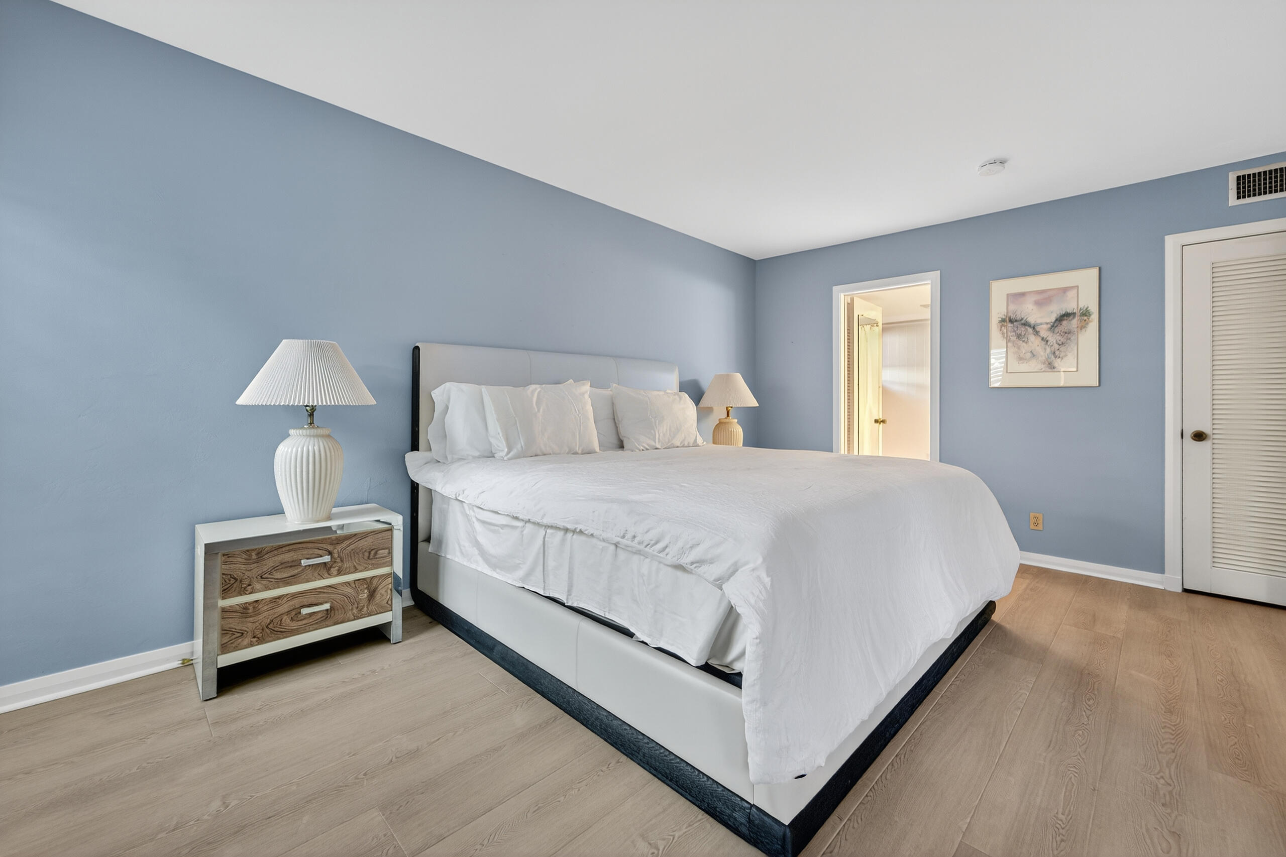 6 Concourse Drive, Unit A Jupiter, FL 33469 - Photo 9 of 49 a bedroom with a bed and a night stand