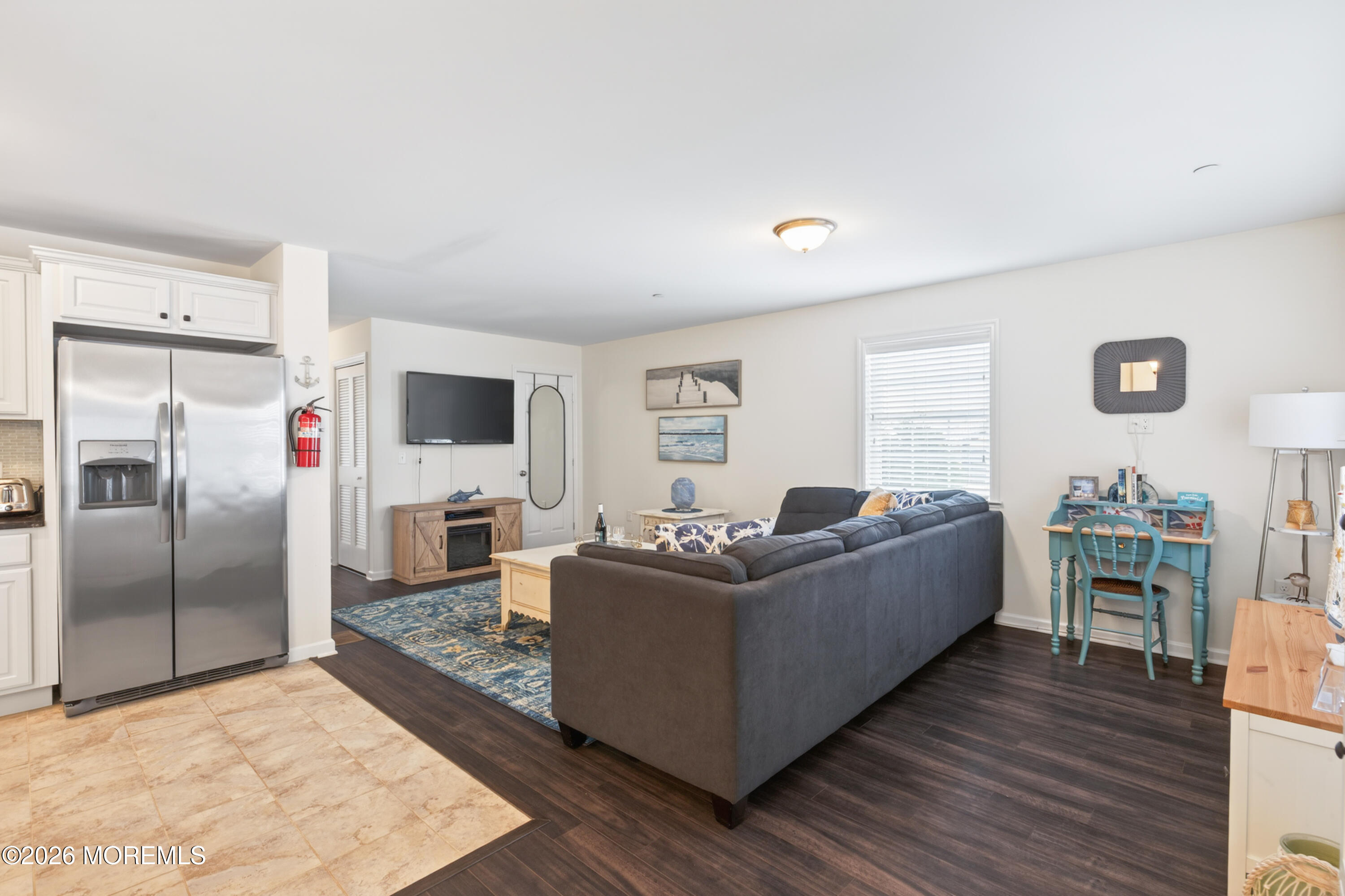 2033 Highway 35, Unit 3 Seaside Heights, NJ 08751 - Photo 15 of 45 a living room with furniture a flat screen tv and a refrigerator