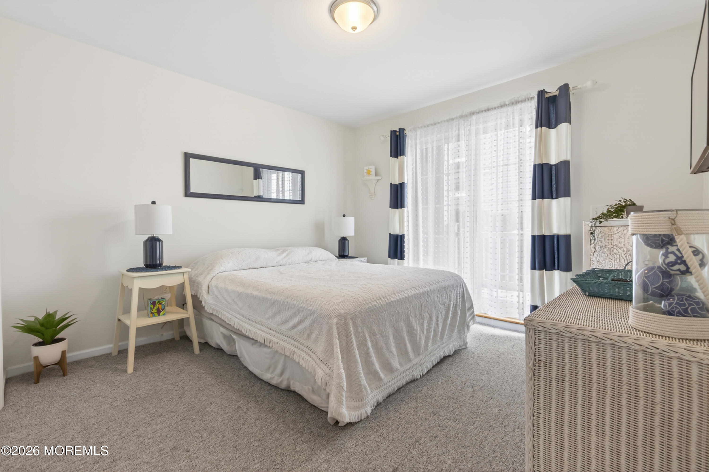 2033 Highway 35, Unit 3 Seaside Heights, NJ 08751 - Photo 20 of 45 a bedroom with a bed and a table