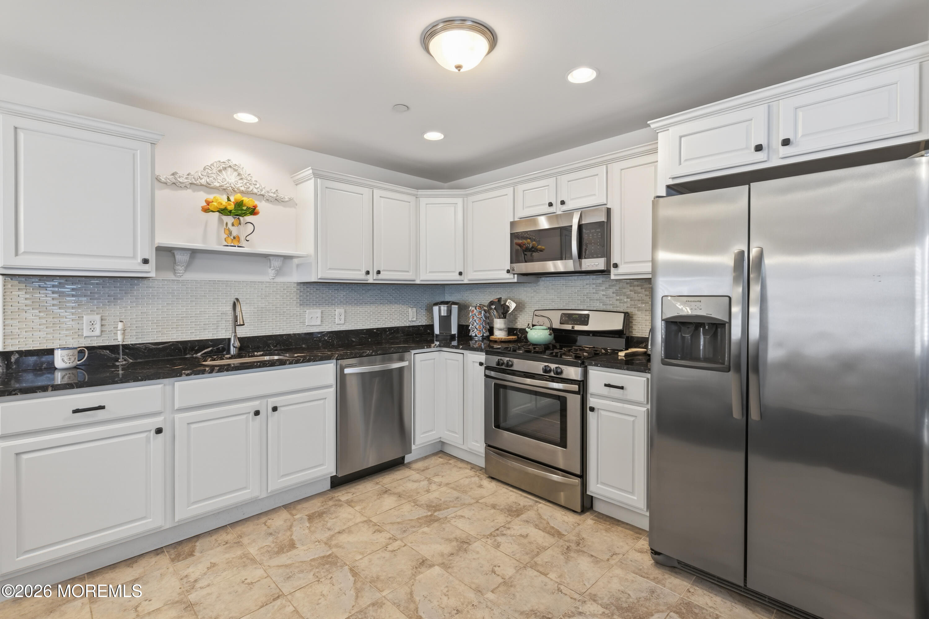 2033 Highway 35, Unit 3 Seaside Heights, NJ 08751 - Photo 10 of 45 a kitchen with stainless steel appliances granite countertop a refrigerator a stove a sink and a microwave