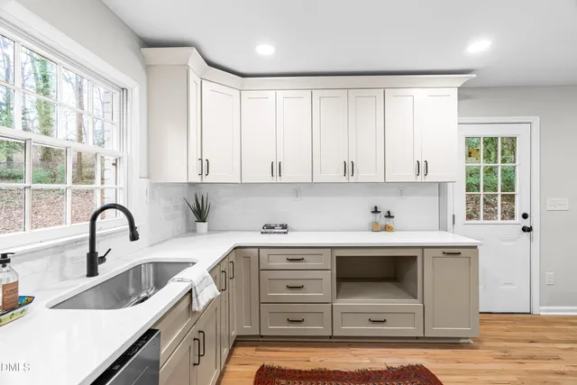 a kitchen with a sink cabinets and window