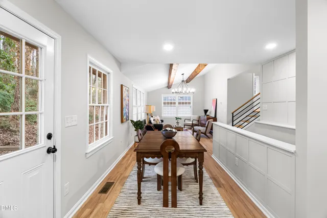 a dining room with furniture a rug and wooden floor