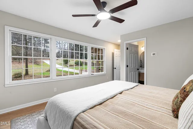 a bedroom with a large bed and a large window