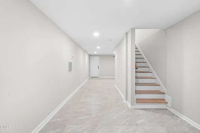 a view of a hallway with stairs